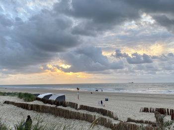 Scenic view of beach against sky during sunset