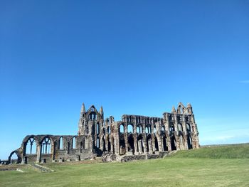 View of old ruin building against blue sky