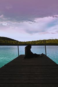 Pier over lake against sky