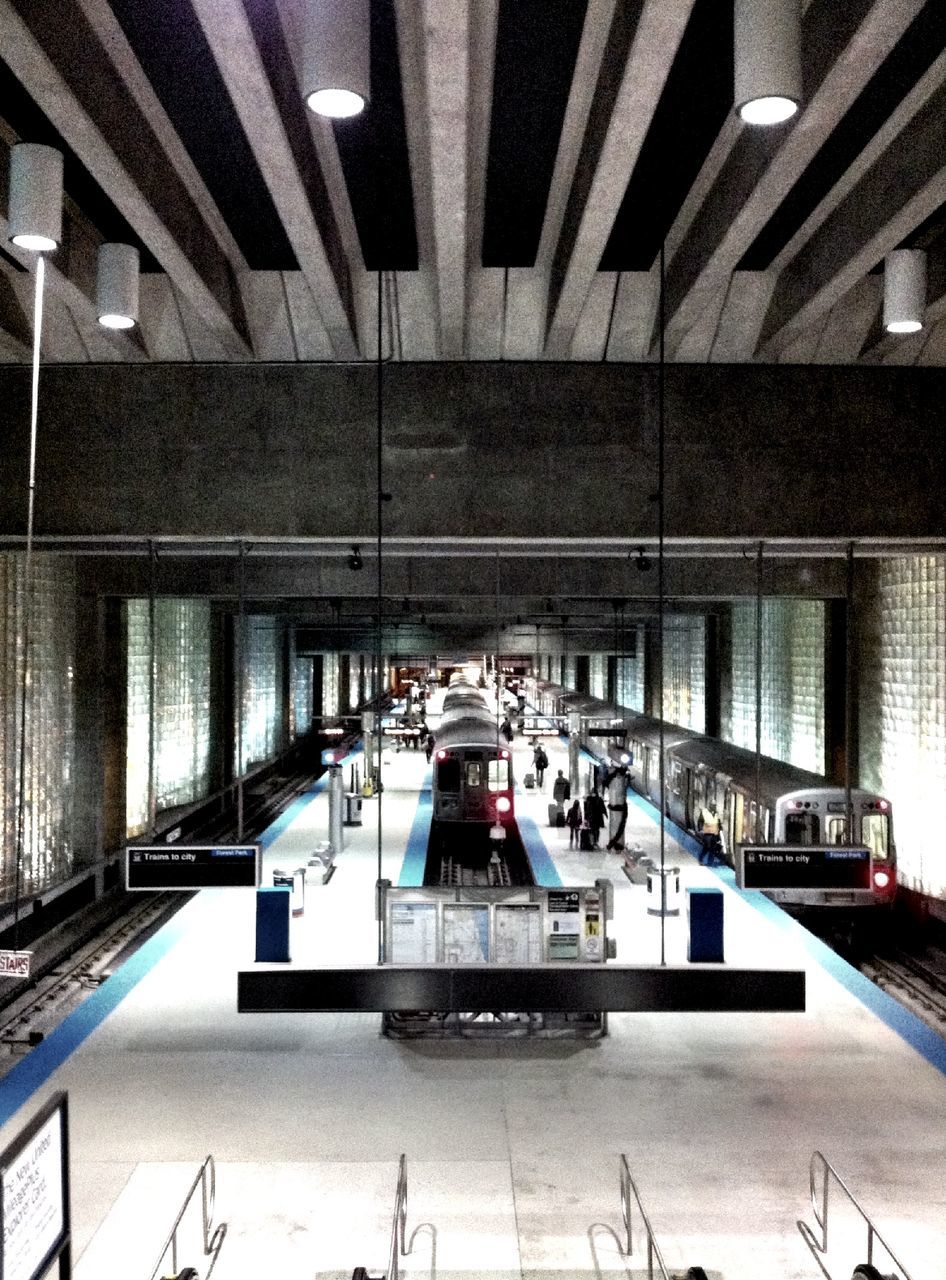 architecture, built structure, building exterior, railroad station, public transportation, rail transportation, transportation, modern, railroad station platform, city, railroad track, incidental people, railing, building, day, glass - material, reflection, indoors, travel, window