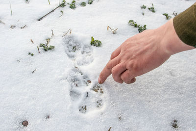 High angle view of man lying on snow