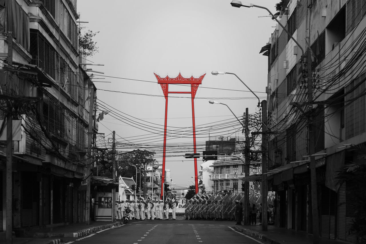 STREET AMIDST BUILDINGS AGAINST SKY