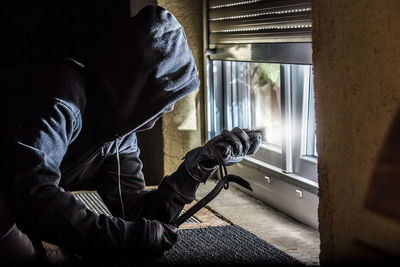 Close-up of thief peeking at home