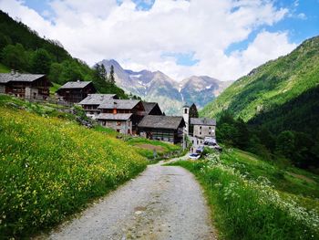 Scenic view of houses and mountains against sky