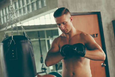 Shirtless boxer practicing boxing
