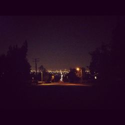 View of illuminated street lights at night