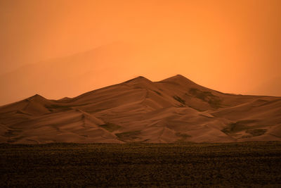 Scenic view of desert against sky during sunset in great sand dunes national park - colorado