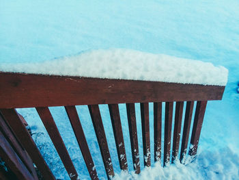 Snow covered land against blue sky