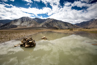Scenic view of lake and mountains against sky
