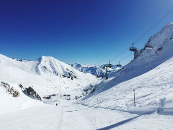 Scenic view of snow covered mountains against clear sky