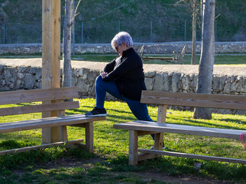 Full length of senior woman exercising in park