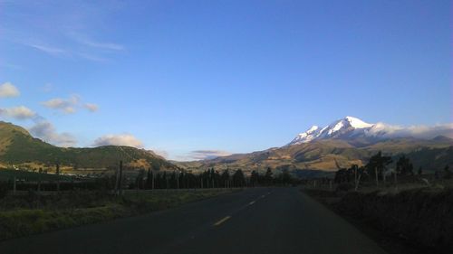 Country road leading towards mountains