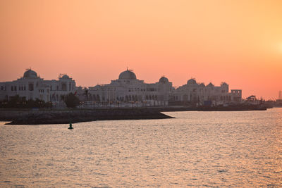 Buildings in city during sunset