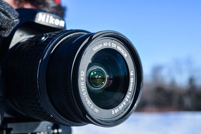 Close-up of camera against blue sky