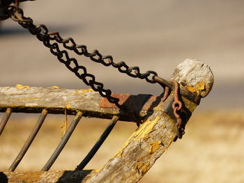 Close-up of chain on wood