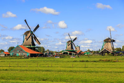 Traditional windmill on field against sky