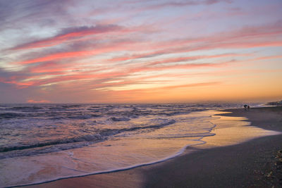 Scenic view of beach against sky during sunset