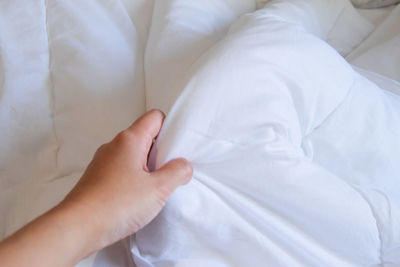 Midsection of woman lying on bed