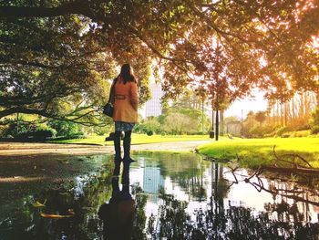 Full length of woman standing in water