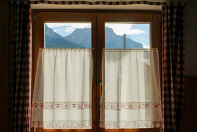 Open window of house against sky