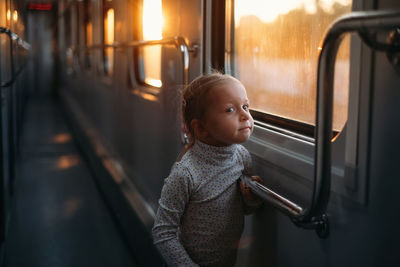 Rear view of boy looking at railroad station