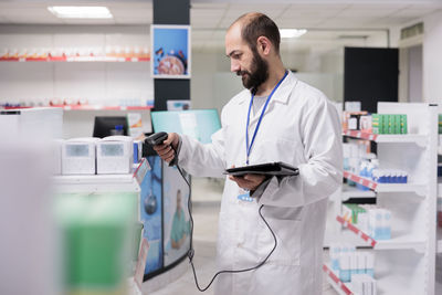 Side view of female doctor standing in hospital
