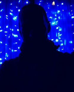 Portrait of silhouette man against illuminated lights