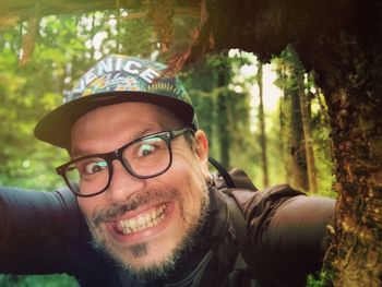 Portrait of smiling young man in forest