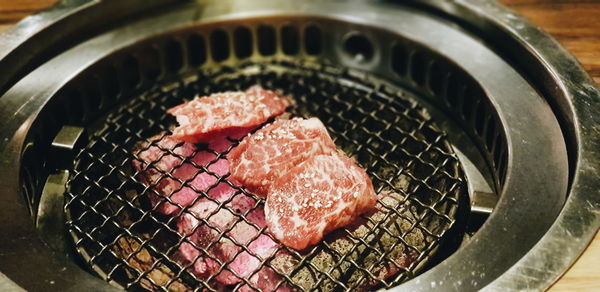 High angle view of meat on barbecue grill