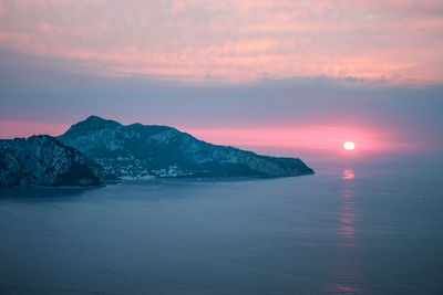 Scenic view of sea against romantic sky at sunset