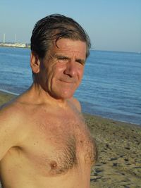 Close-up of shirtless man looking at sea