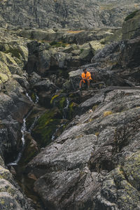 A young man sits back and relax while drinking water, sierra de gredos