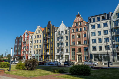 Buildings against clear blue sky in city