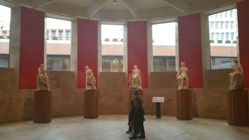 Rear view of woman standing in corridor of building