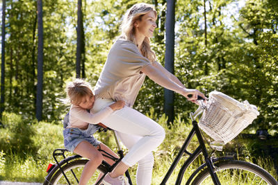 Side view of woman riding bicycle