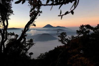 Scenic view of silhouette mountains against sky at sunset