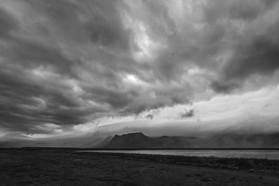 Scenic view of sea against storm clouds
