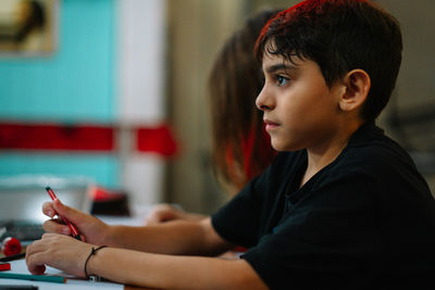 Portrait of student kid holding a pencil