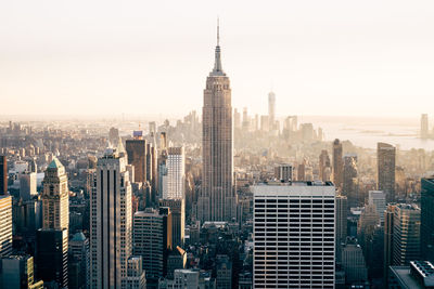 High angle view of city with empire state building against clear sky