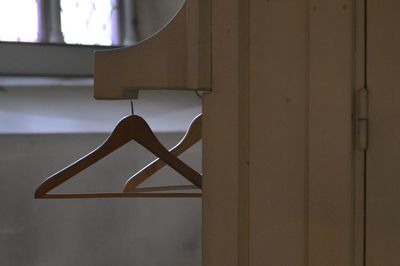 Close-up of clothes hanging on wall at home