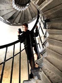 Portrait of boy standing on staircase