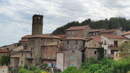 Buildings in town against sky