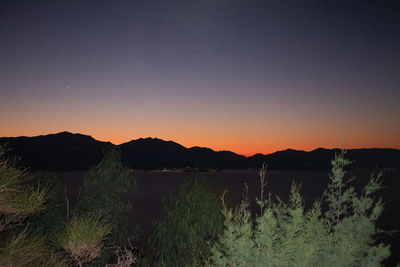 Scenic view of mountains against clear sky during sunset