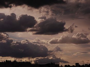 Low angle view of storm clouds over city