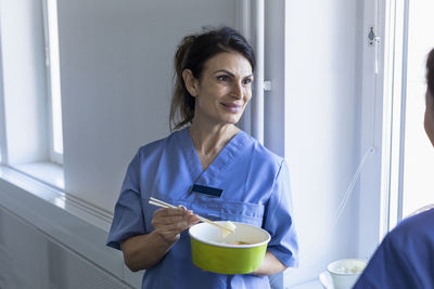 Nurse eating asian take-out food