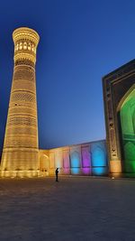 Low angle view of illuminated building against blue sky