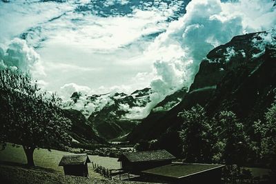 Scenic view of mountains against cloudy sky