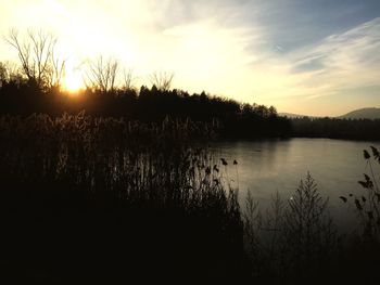 Scenic view of lake against sky during sunset