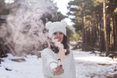 Portrait of young woman standing in snow