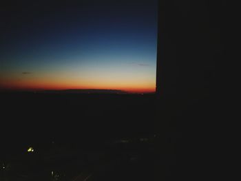 Silhouette landscape against sky at night